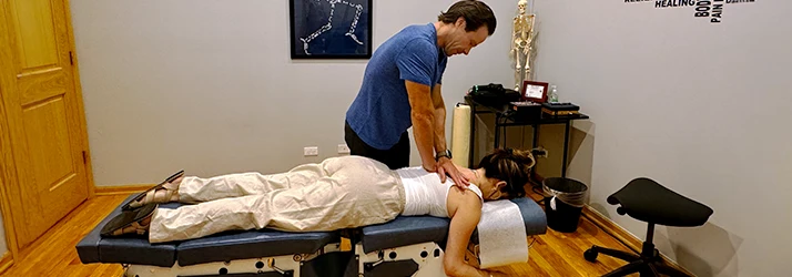 Chiropractor Roscoe Village Chicago IL Michael Karl Adjusting Female Patient Insurance